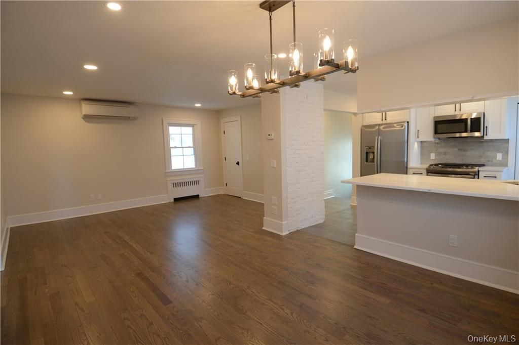 Chandelier, Empty room, Interior, Kitchen, Pendant Lights, Recessed Lighting, Stainless Steel Appliances, Wood Texture Flooring