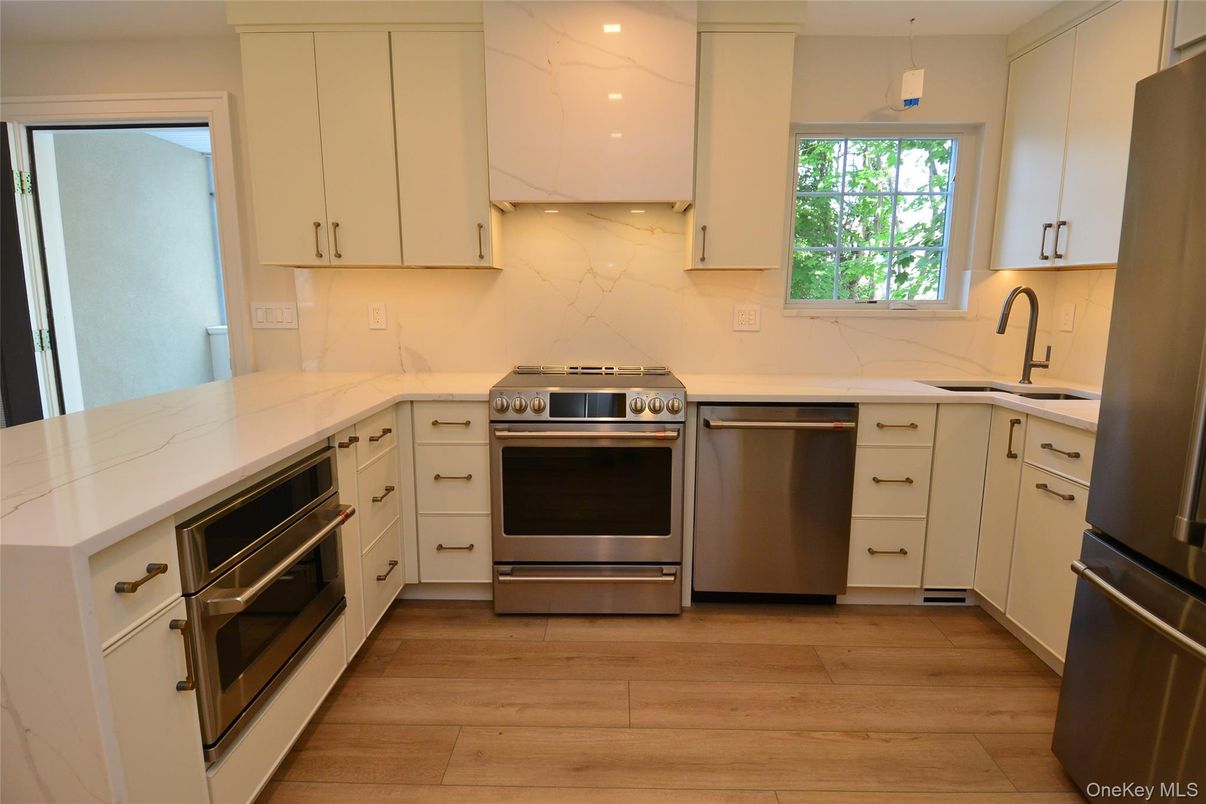 Interior, Kitchen, Marble Walls, Recessed Lighting, Stainless Steel Appliances, Wood Texture Flooring