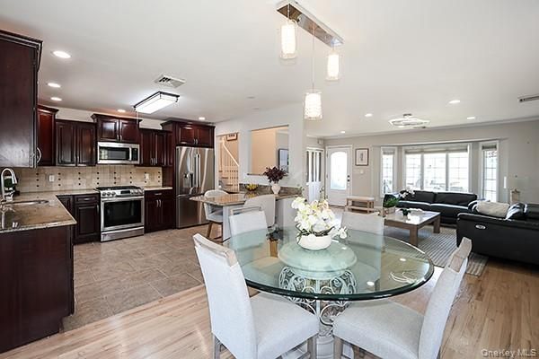 Dining room, Interior, Kitchen, Living room, Pendant Lights, Recessed Lighting, Stainless Steel Appliances, Wood Texture Flooring