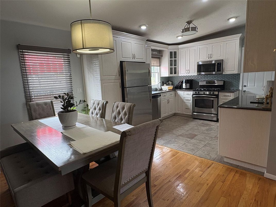 Dining room, Interior, Kitchen, Pendant Lights, Recessed Lighting, Stainless Steel Appliances, Wood Texture Flooring
