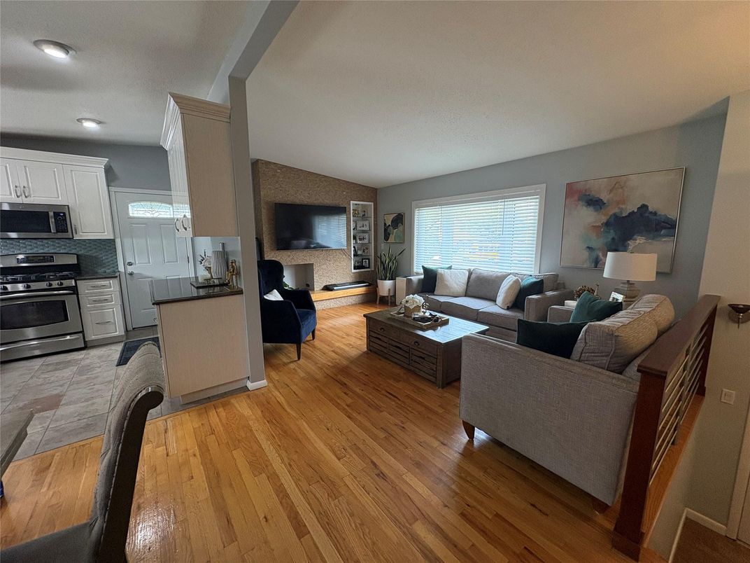 Fireplace, Interior, Kitchen, Living room, Recessed Lighting, Stainless Steel Appliances, Stone Walls, Wood Texture Flooring
