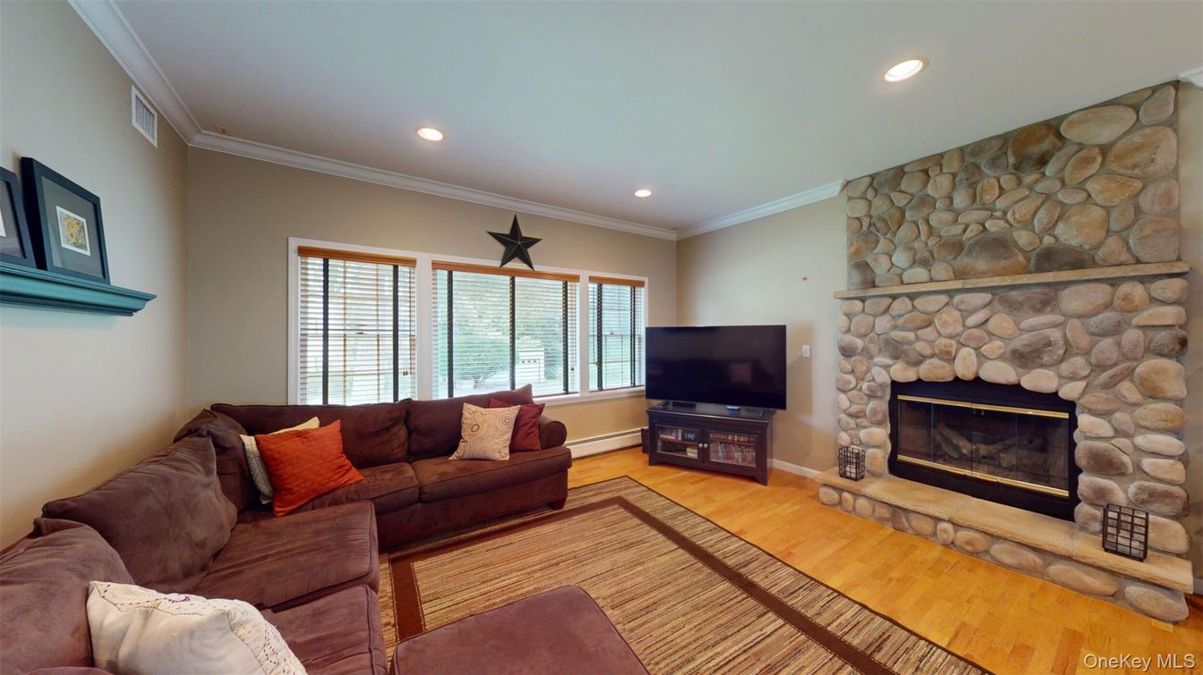 Fireplace, Interior, Living room, Recessed Lighting, Stone Walls, Wood Texture Flooring