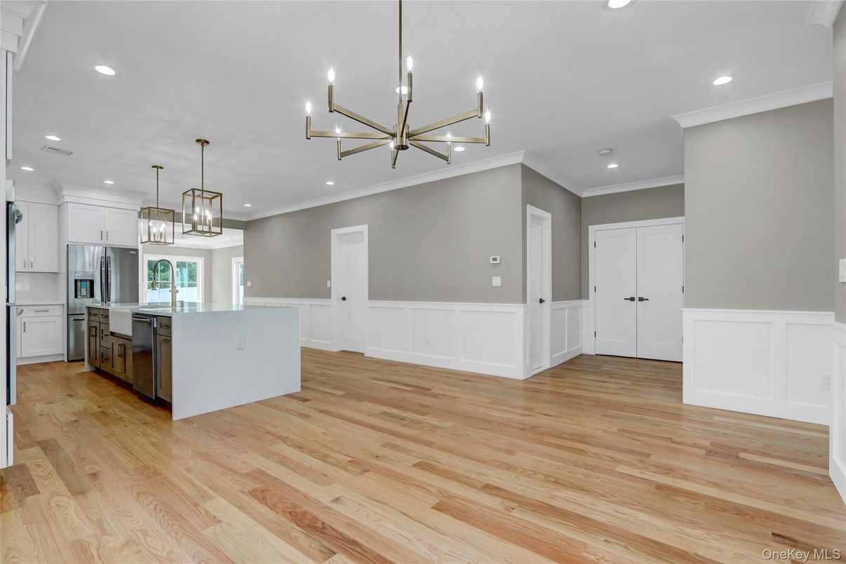 Empty room, Interior, Kitchen, Pendant Lights, Recessed Lighting, Stainless Steel Appliances, Wood Texture Flooring