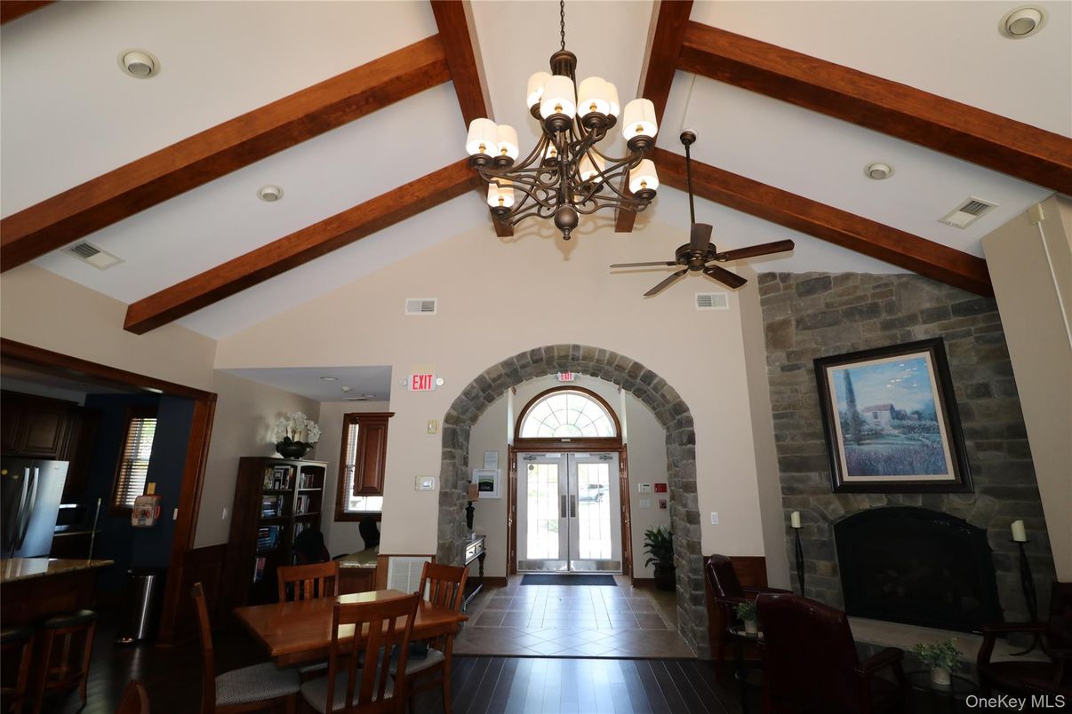 Chandelier, Dining room, Fireplace, Interior, Recessed Lighting, Stone Walls, Wooden Beams, Wood Texture Flooring