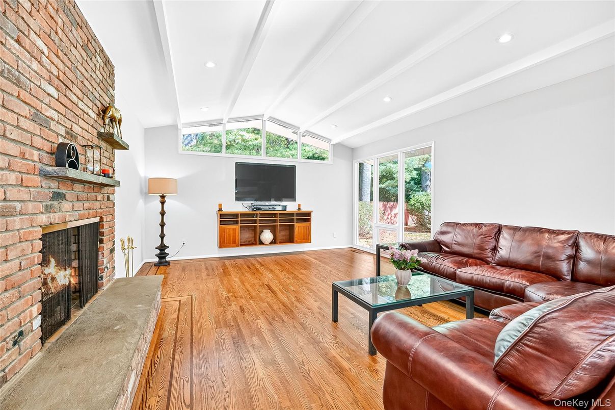 Fireplace, Interior, Living room, Recessed Lighting, Stone Walls, Wood Texture Flooring