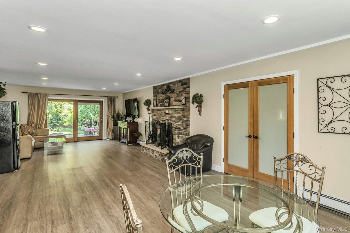 Dining room, Fireplace, Interior, Recessed Lighting, Stone Walls, Wood Texture Flooring