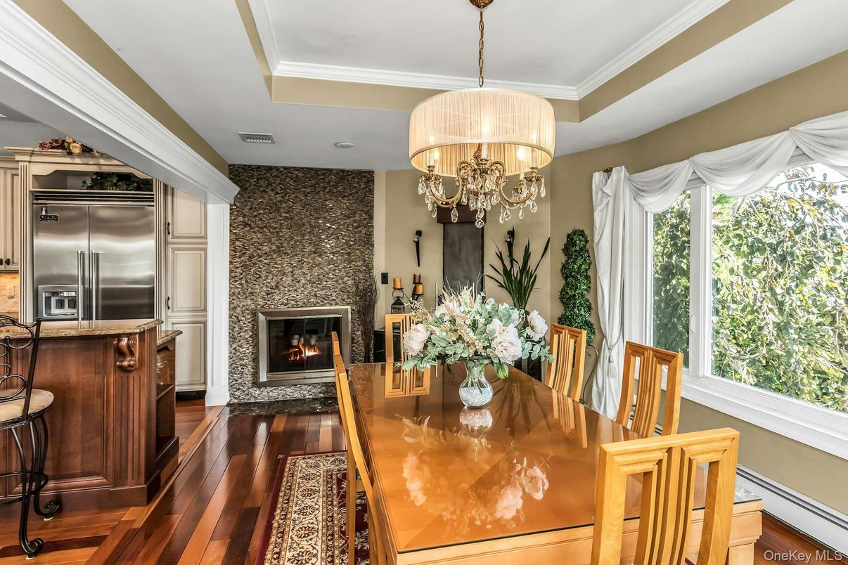 Chandelier, Dining room, Fireplace, Interior, Kitchen, Stainless Steel Appliances, Stone Walls, Wood Texture Flooring