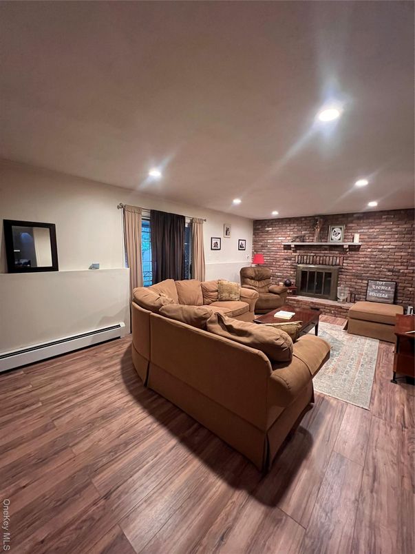 Fireplace, Interior, Living room, Recessed Lighting, Stone Walls, Wood Texture Flooring