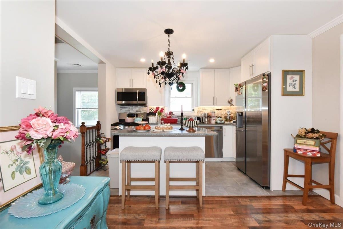 Chandelier, Dining room, Interior, Kitchen, Recessed Lighting, Stainless Steel Appliances, Wood Texture Flooring