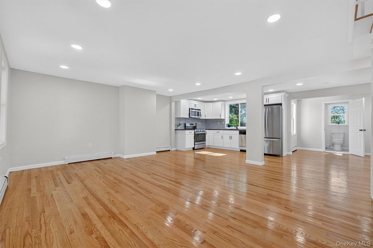Empty room, Interior, Kitchen, Recessed Lighting, Stainless Steel Appliances, Wood Texture Flooring