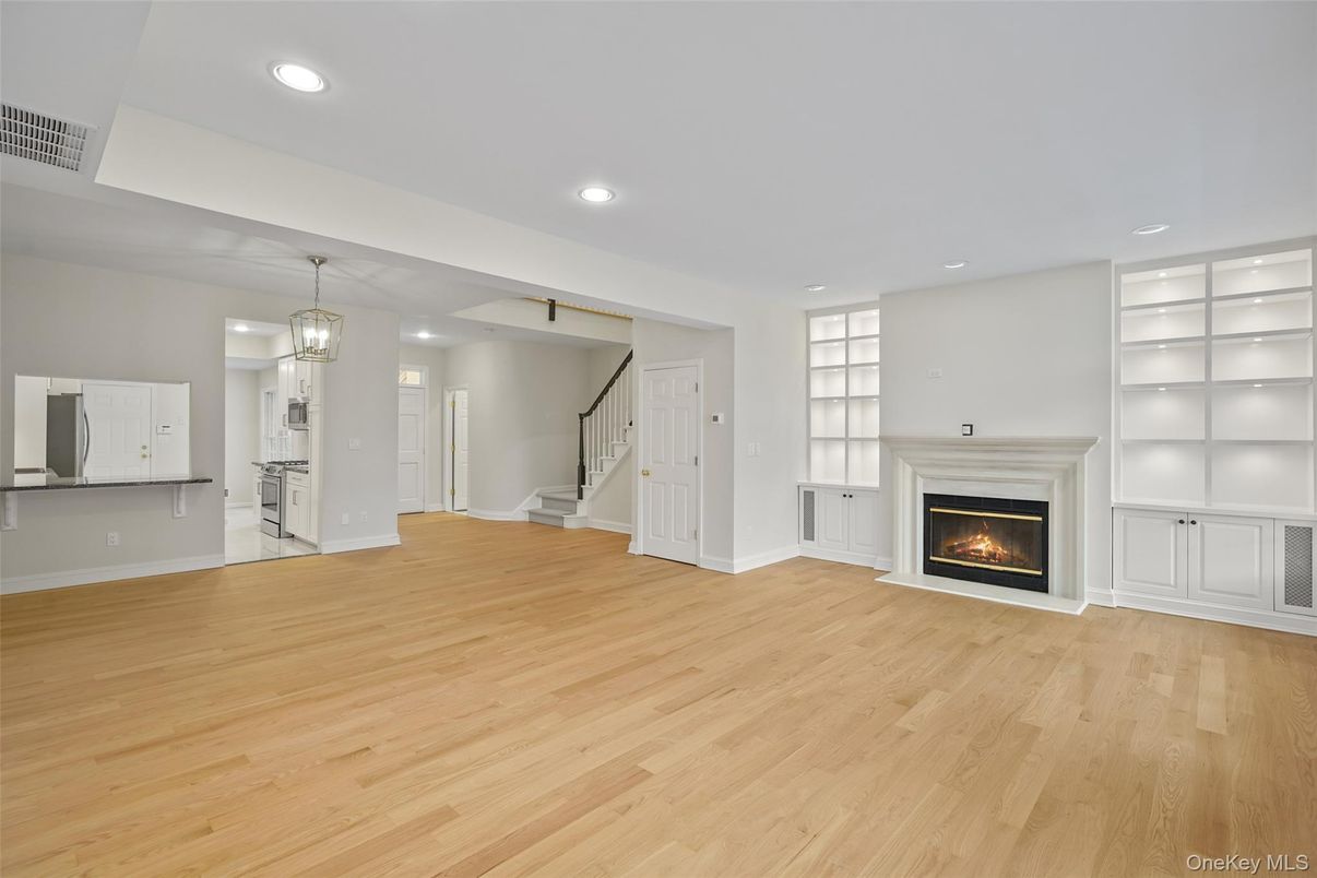 Chandelier, Empty room, Fireplace, Interior, Pendant Lights, Recessed Lighting, Wood Texture Flooring