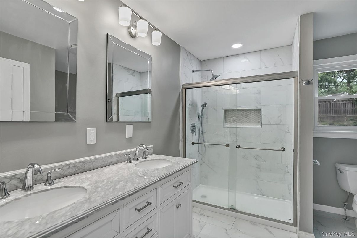 Bathroom, Dual Sink Vanities, Glass Shower, Interior, Marble, Marble Walls, Recessed Lighting