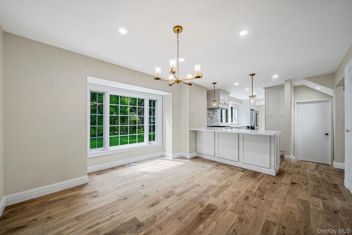 Empty room, Interior, Kitchen, Pendant Lights, Recessed Lighting, Stainless Steel Appliances, Wood Texture Flooring