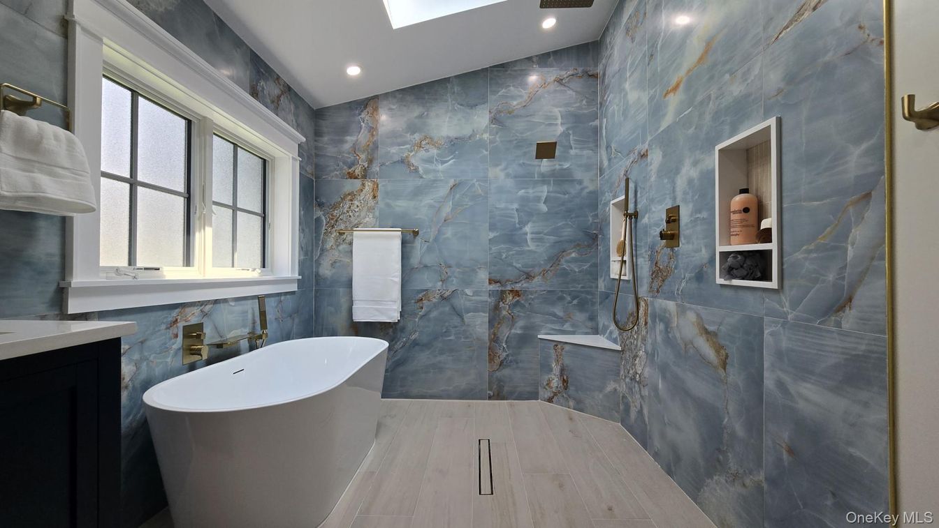 Bathroom, Free Standing Baths, Interior, Marble Walls, Recessed Lighting, Wood Texture Flooring