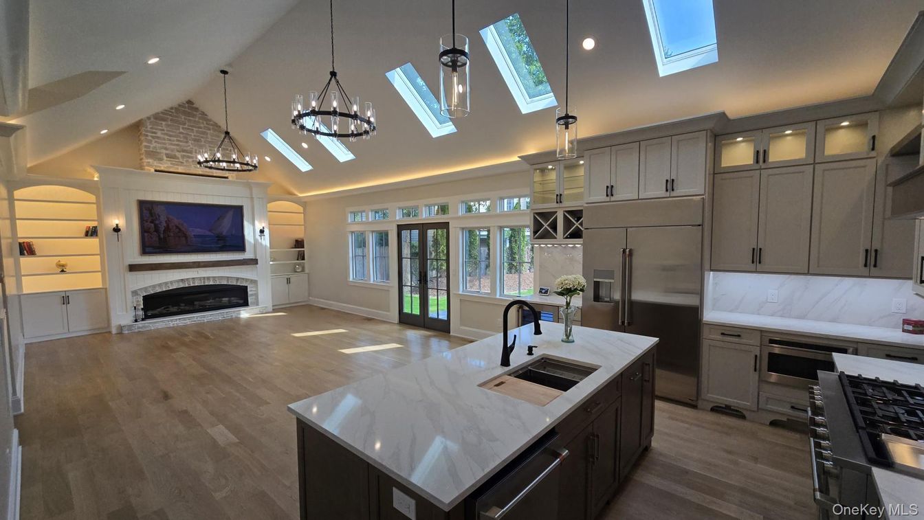 Chandelier, Fireplace, Interior, Kitchen, Pendant Lights, Recessed Lighting, Stainless Steel Appliances, Wood Texture Flooring