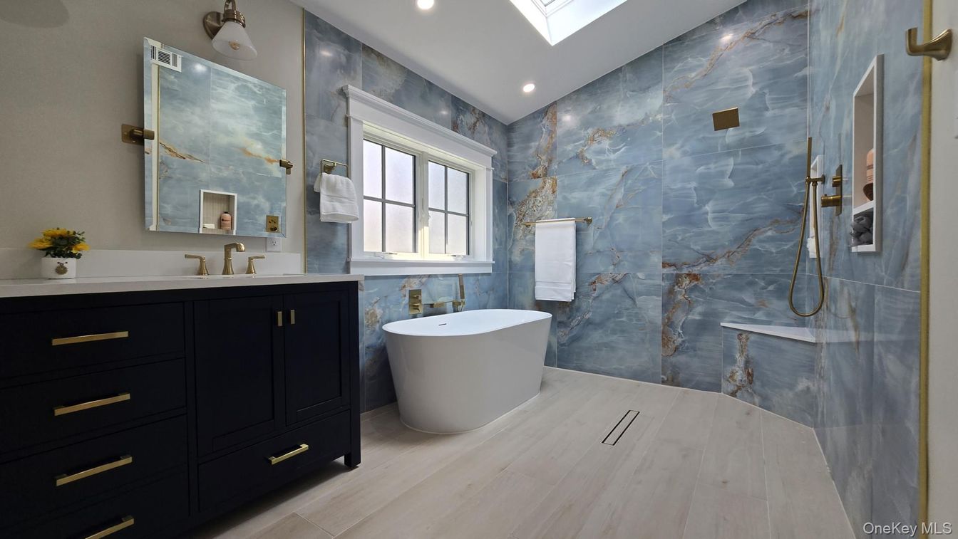 Bathroom, Dual Sink Vanities, Free Standing Baths, Interior, Marble Walls, Recessed Lighting, Wood Texture Flooring