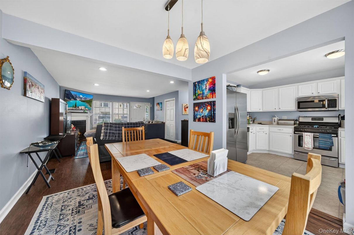 Dining room, Fireplace, Interior, Kitchen, Living room, Pendant Lights, Recessed Lighting, Stainless Steel Appliances, Wood Texture Flooring
