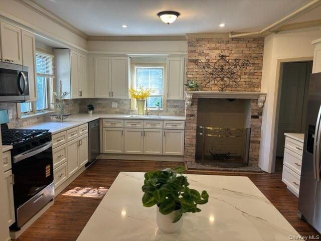 Fireplace, Interior, Kitchen, Recessed Lighting, Stainless Steel Appliances, Stone Walls, Wood Texture Flooring