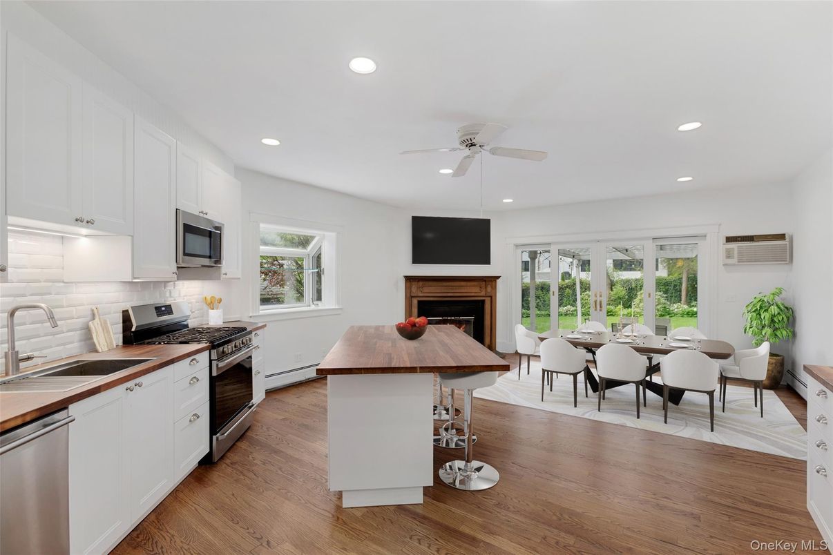 Dining room, Fireplace, Interior, Kitchen, Recessed Lighting, Stainless Steel Appliances, Wood Texture Flooring