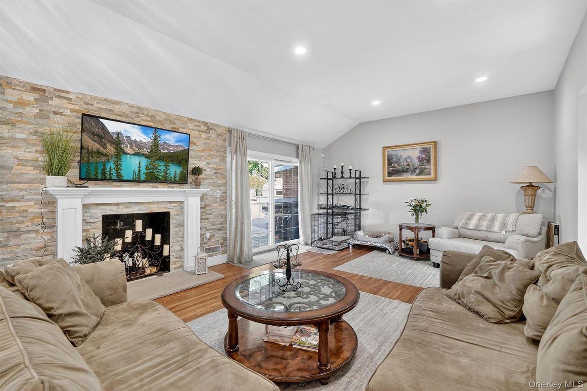 Fireplace, Interior, Living room, Recessed Lighting, Stone Walls, Wood Texture Flooring