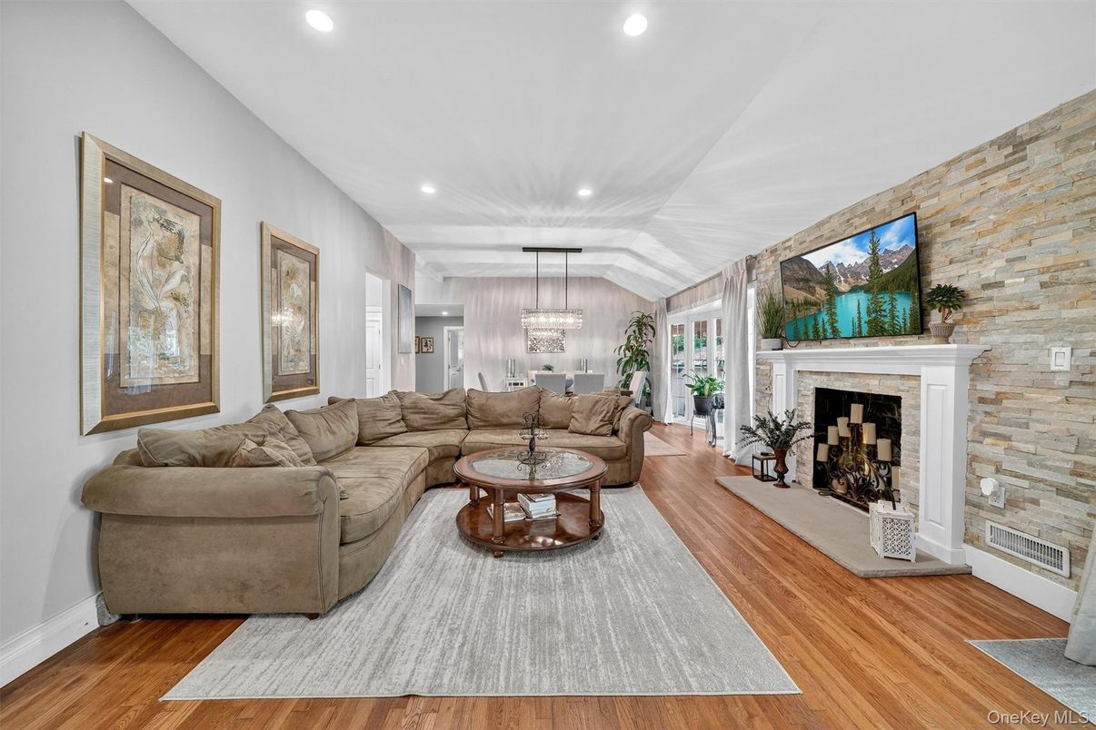 Chandelier, Fireplace, Interior, Living room, Recessed Lighting, Stone Walls, Wood Texture Flooring