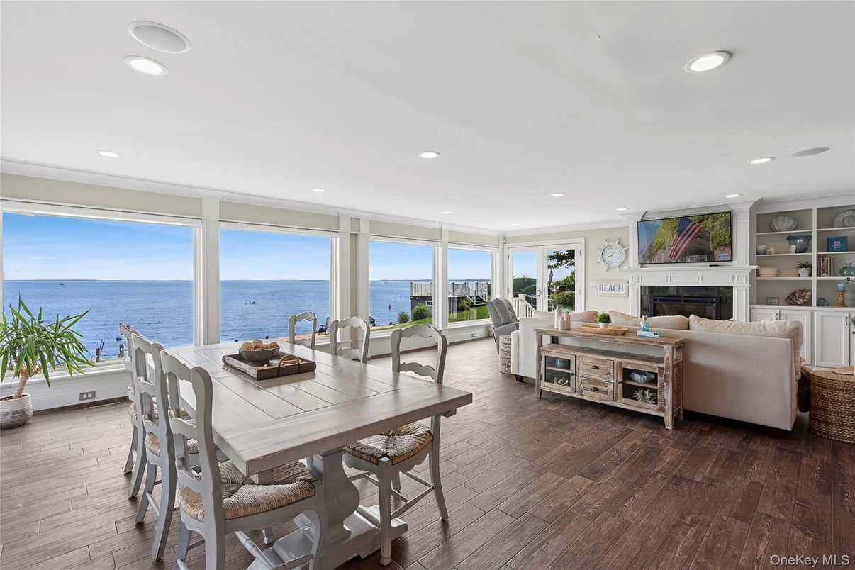 Dining room, Fireplace, Interior, Living room, Recessed Lighting, Water, Wood Texture Flooring