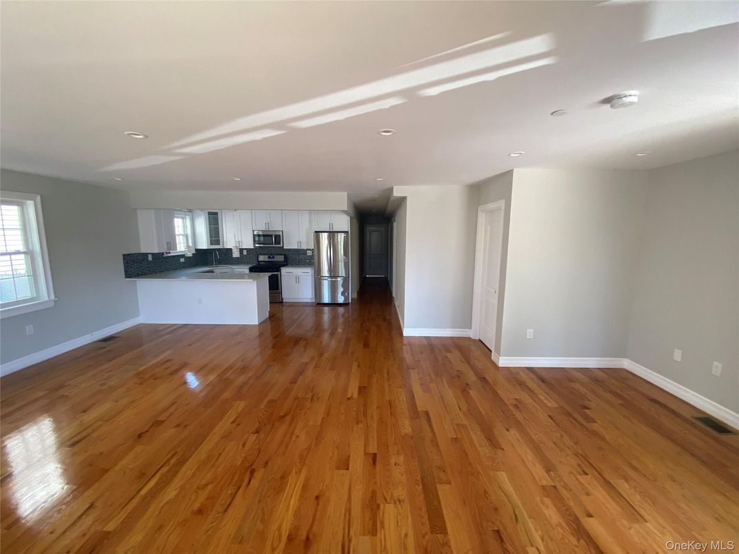 Empty room, Interior, Kitchen, Recessed Lighting, Stainless Steel Appliances, Wood Texture Flooring