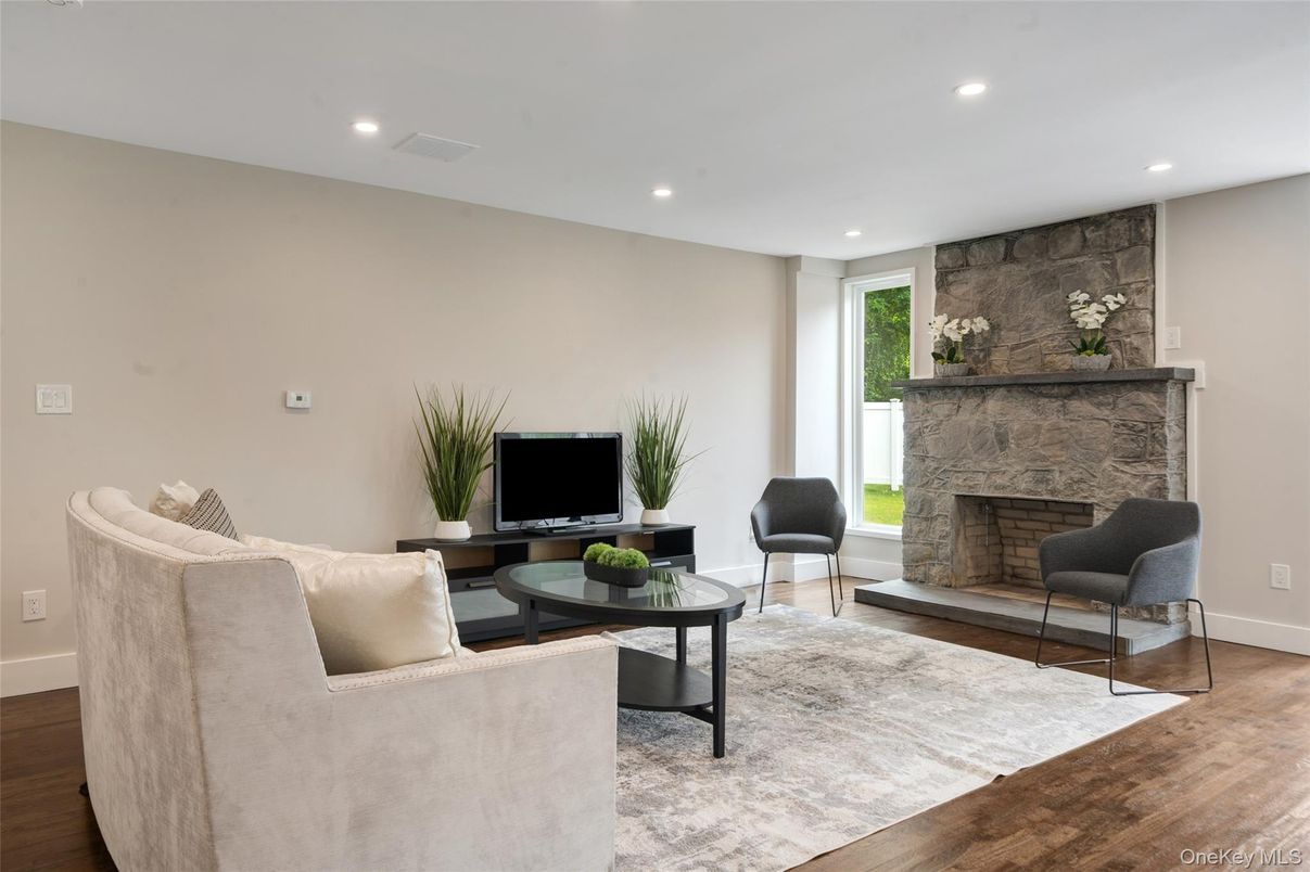 Fireplace, Interior, Living room, Recessed Lighting, Stone Walls, Wood Texture Flooring