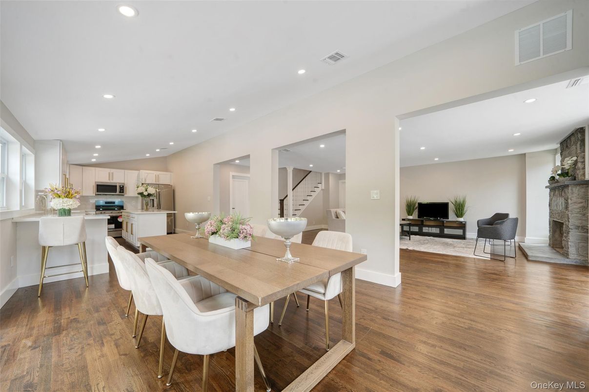 Dining room, Fireplace, Interior, Kitchen, Recessed Lighting, Stainless Steel Appliances, Wood Texture Flooring