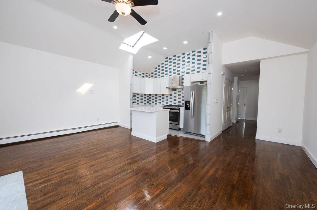 Empty room, Interior, Kitchen, Recessed Lighting, Stainless Steel Appliances, Wood Texture Flooring