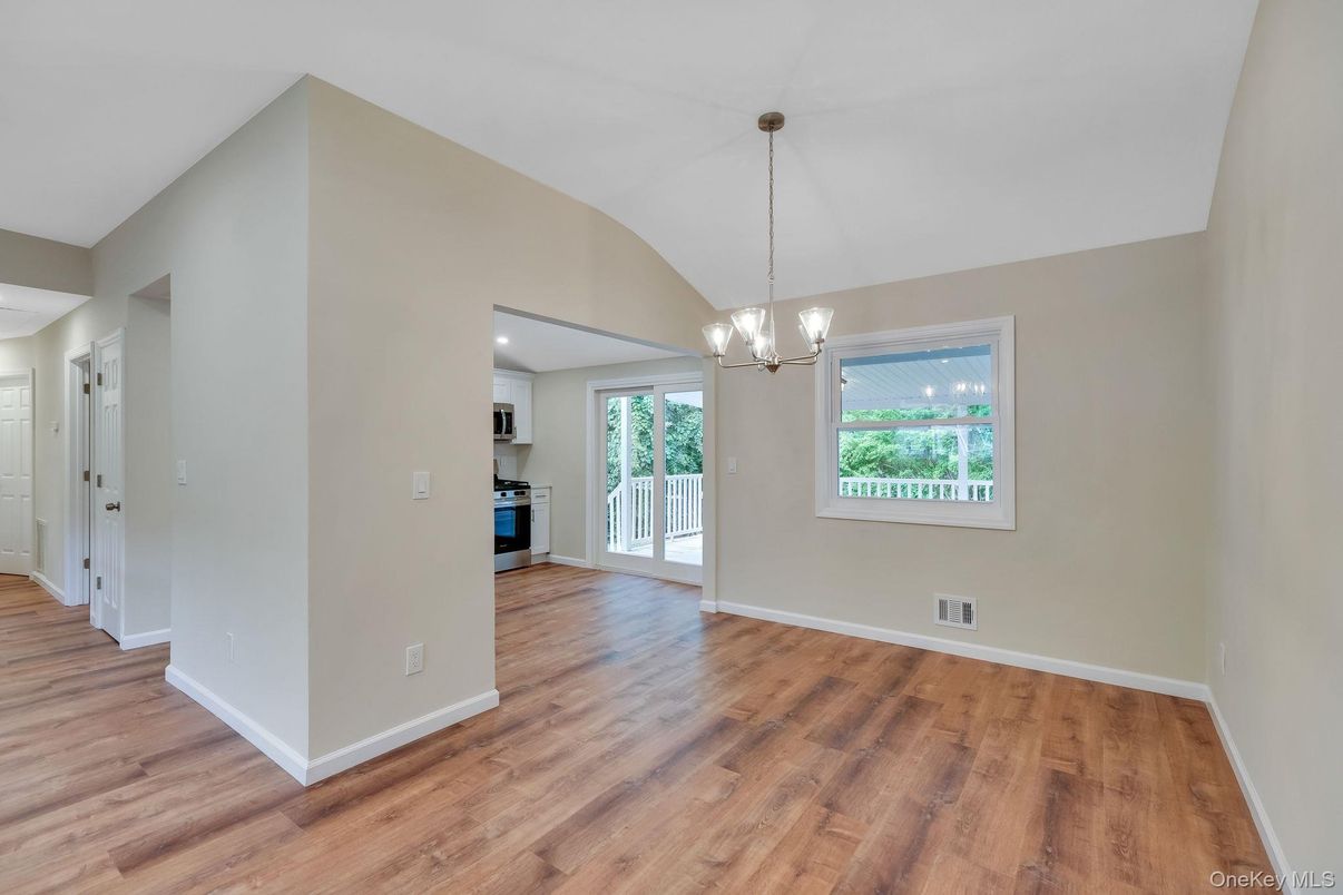 Empty room, Interior, Kitchen, Pendant Lights, Recessed Lighting, Stainless Steel Appliances, Wood Texture Flooring