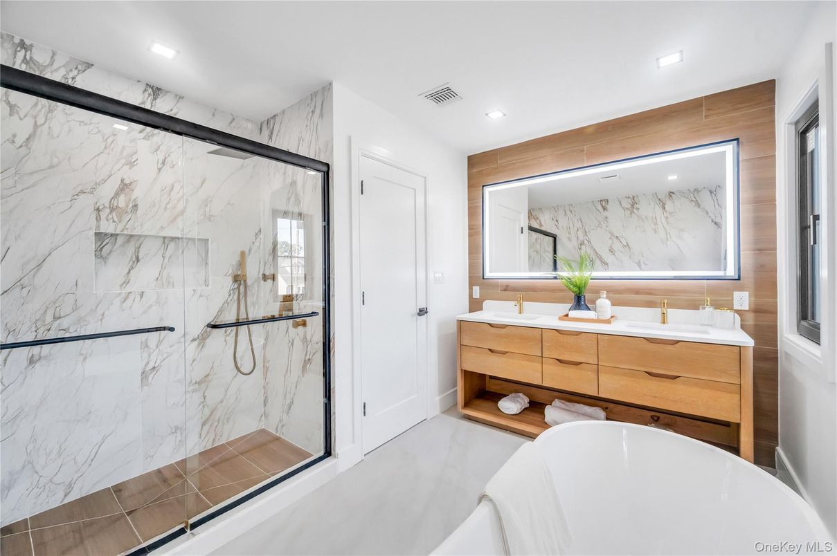 Bathroom, Dual Sink Vanities, Free Standing Baths, Glass Shower, Interior, Marble Walls, Recessed Lighting