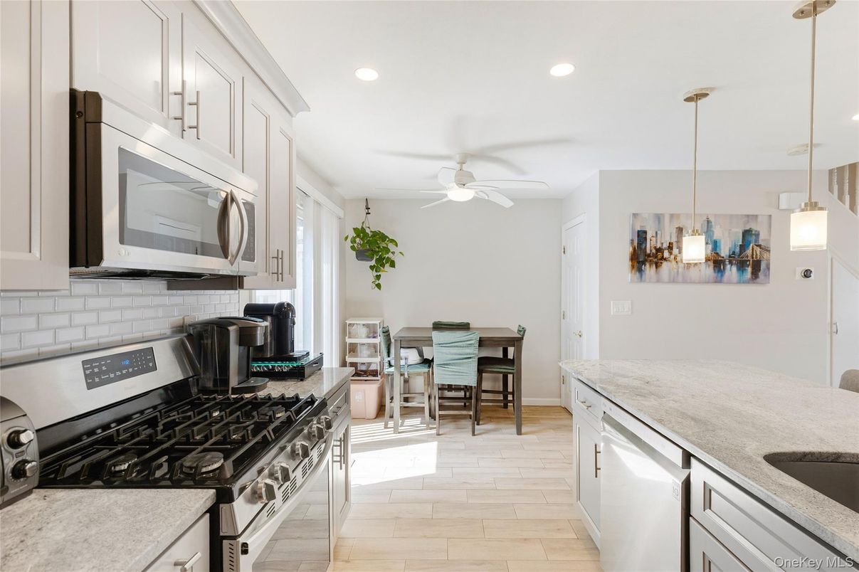 Dining room, Interior, Kitchen, Pendant Lights, Recessed Lighting, Stainless Steel Appliances, Wood Texture Flooring