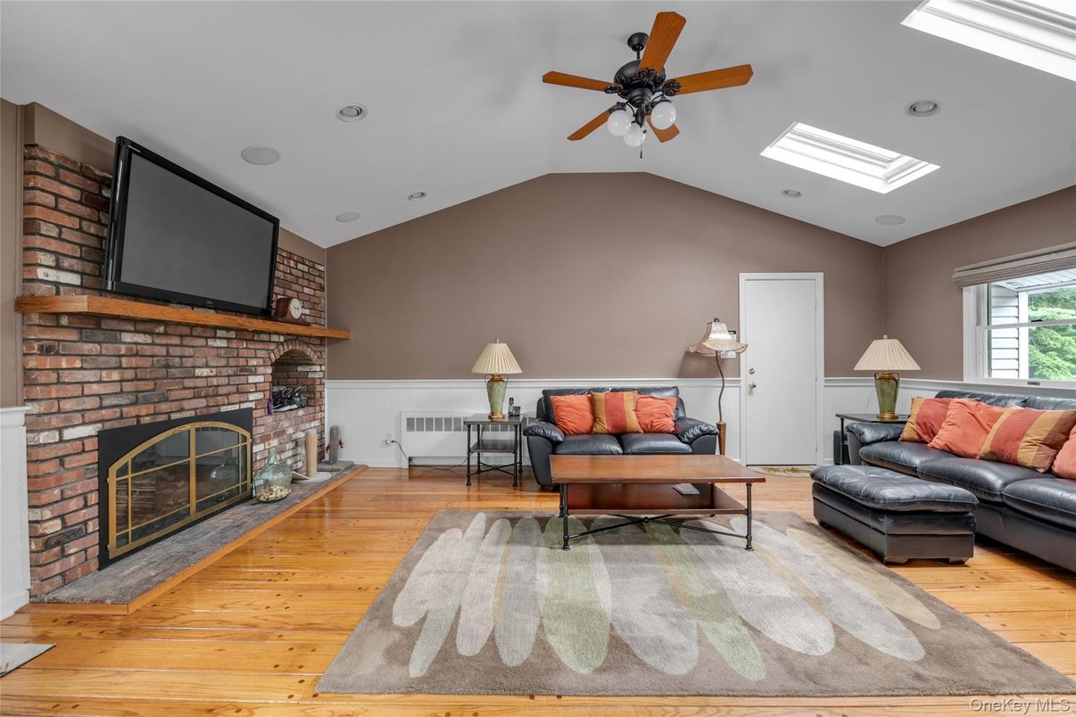 Fireplace, Interior, Living room, Recessed Lighting, Stone Walls, Wood Texture Flooring