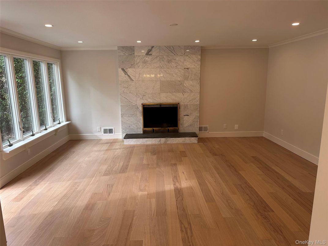 Empty room, Fireplace, Interior, Marble Walls, Recessed Lighting, Wood Texture Flooring
