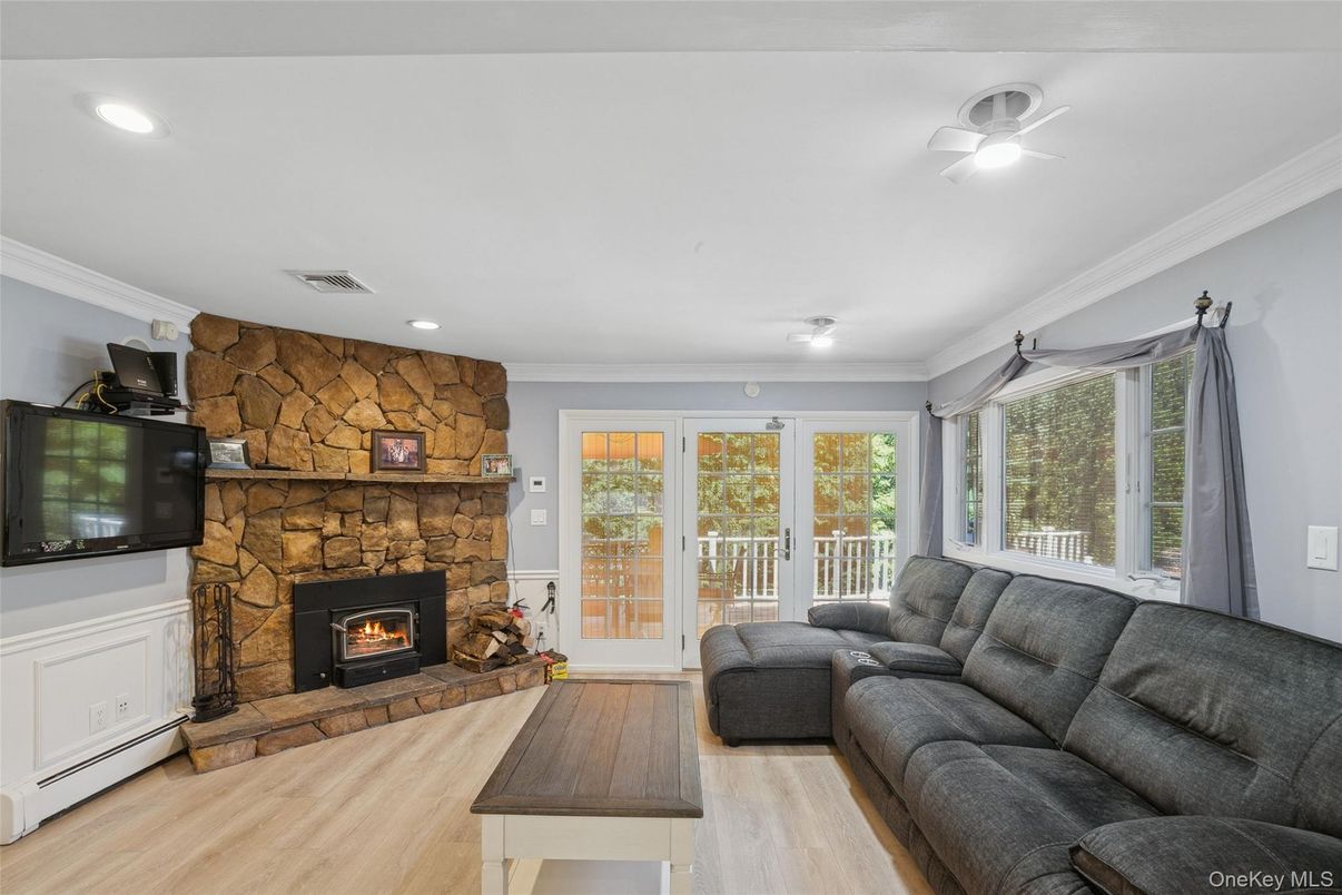 Fireplace, Interior, Living room, Recessed Lighting, Stone Walls, Wood Texture Flooring