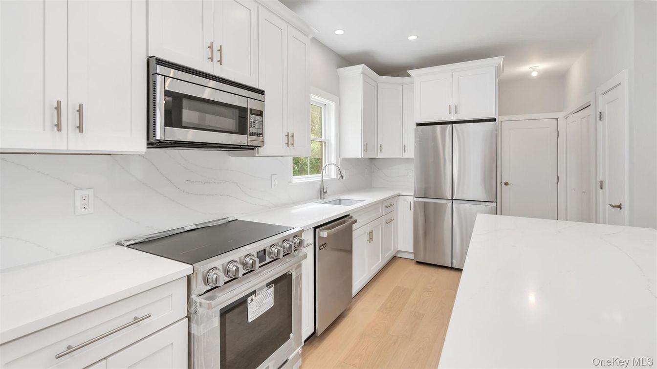 Interior, Kitchen, Marble Walls, Recessed Lighting, Stainless Steel Appliances, Wood Texture Flooring