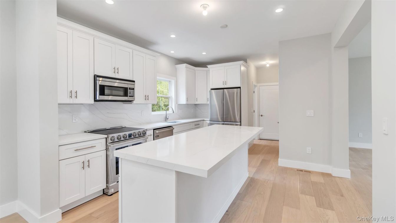 Interior, Kitchen, Marble Walls, Recessed Lighting, Stainless Steel Appliances, Wood Texture Flooring