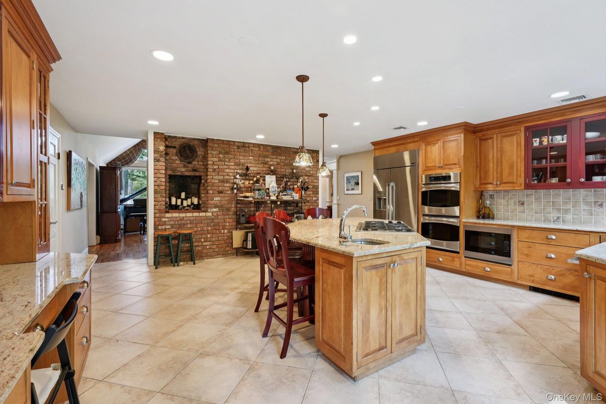 Fireplace, Interior, Kitchen, Pendant Lights, Recessed Lighting, Stainless Steel Appliances, Stone Walls