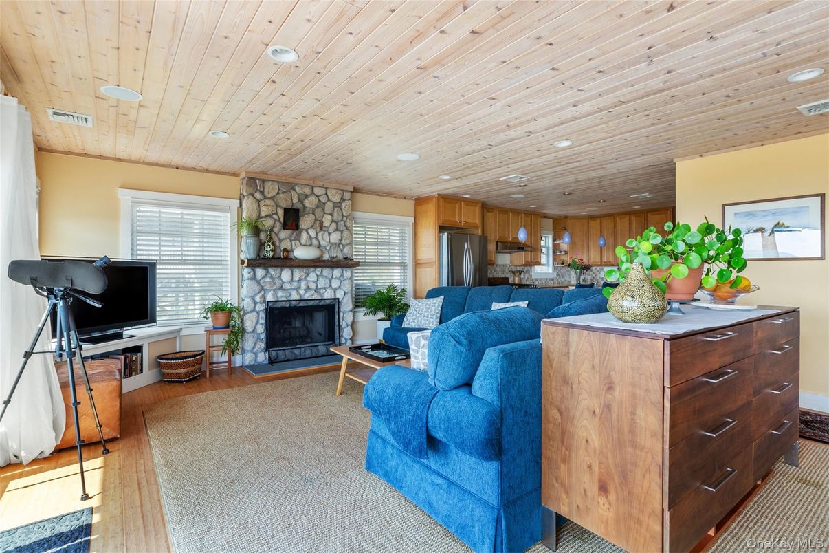 Fireplace, Interior, Kitchen, Living room, Recessed Lighting, Stainless Steel Appliances, Stone Walls, Wooden Ceilings, Wood Texture Flooring