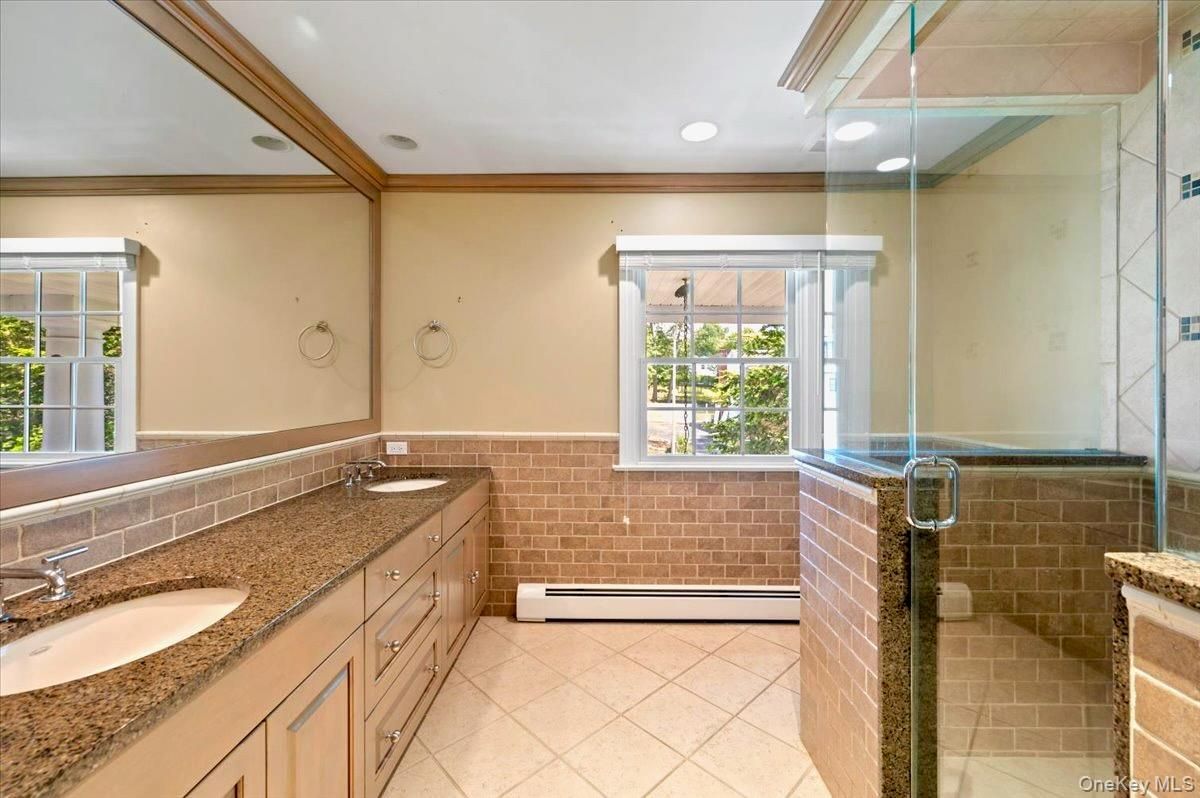 Bathroom, Dual Sink Vanities, Glass Shower, Interior, Recessed Lighting, Stone Walls