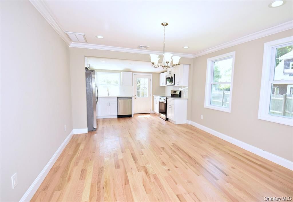 Chandelier, Empty room, Interior, Kitchen, Recessed Lighting, Stainless Steel Appliances, Wood Texture Flooring