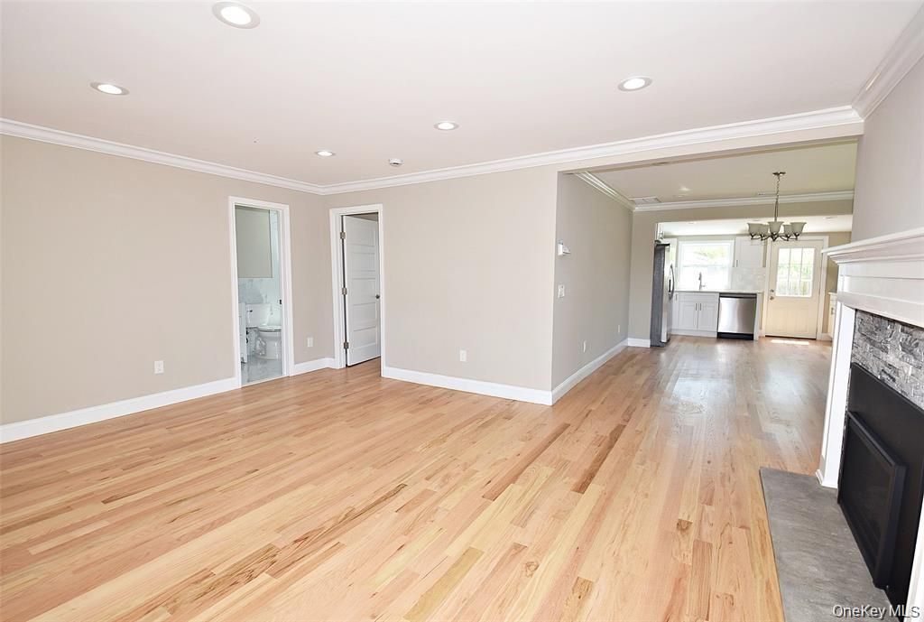 Empty room, Fireplace, Interior, Kitchen, Pendant Lights, Recessed Lighting, Wood Texture Flooring