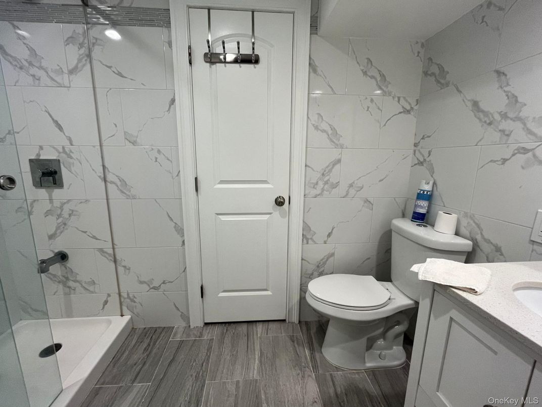 Bathroom, Glass Shower, Interior, Marble Walls, Wood Texture Flooring