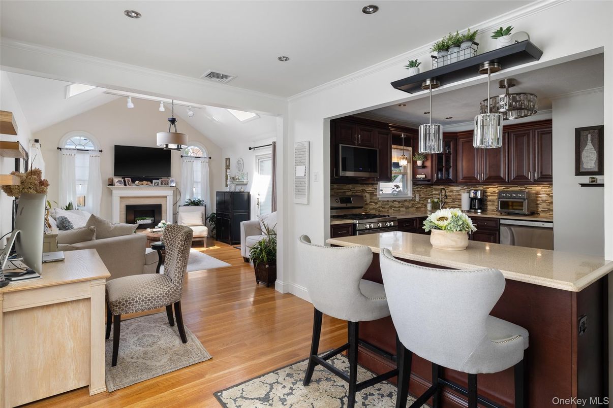 Dining room, Fireplace, Interior, Kitchen, Living room, Pendant Lights, Recessed Lighting, Stainless Steel Appliances, Wood Texture Flooring