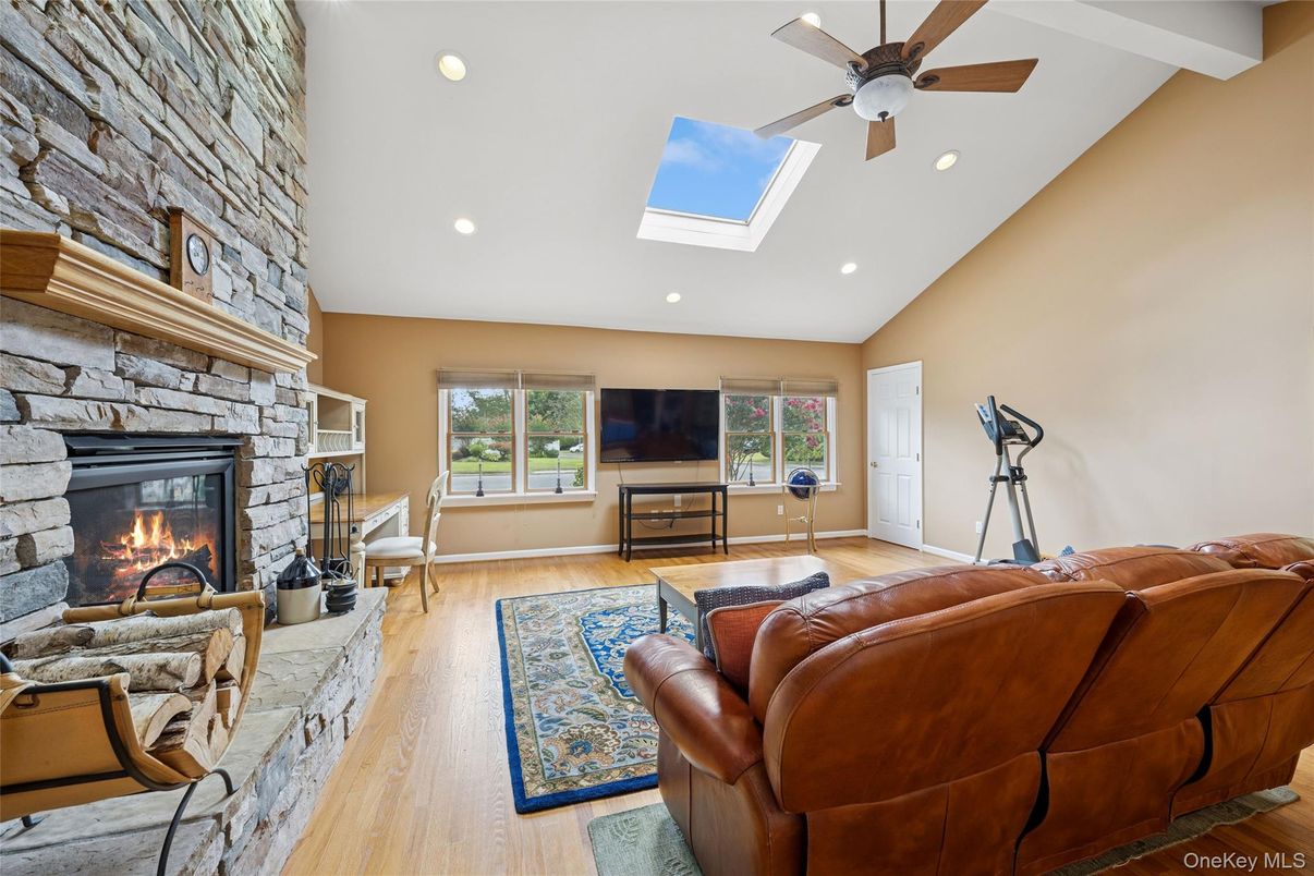 Fireplace, Interior, Living room, Recessed Lighting, Stone Walls, Wood Texture Flooring