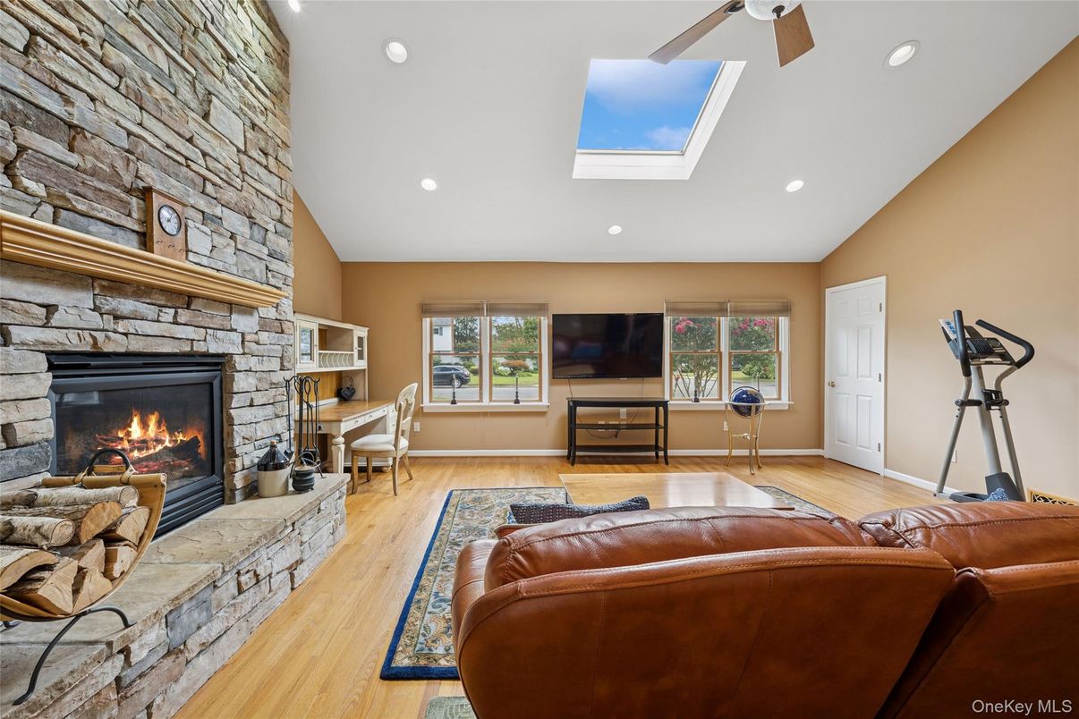 Fireplace, Interior, Living room, Recessed Lighting, Stone Walls, Wood Texture Flooring