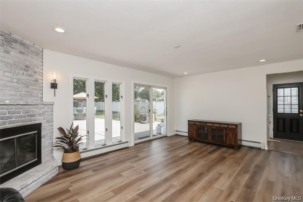 Empty room, Fireplace, Interior, Recessed Lighting, Stone Walls, Wood Texture Flooring