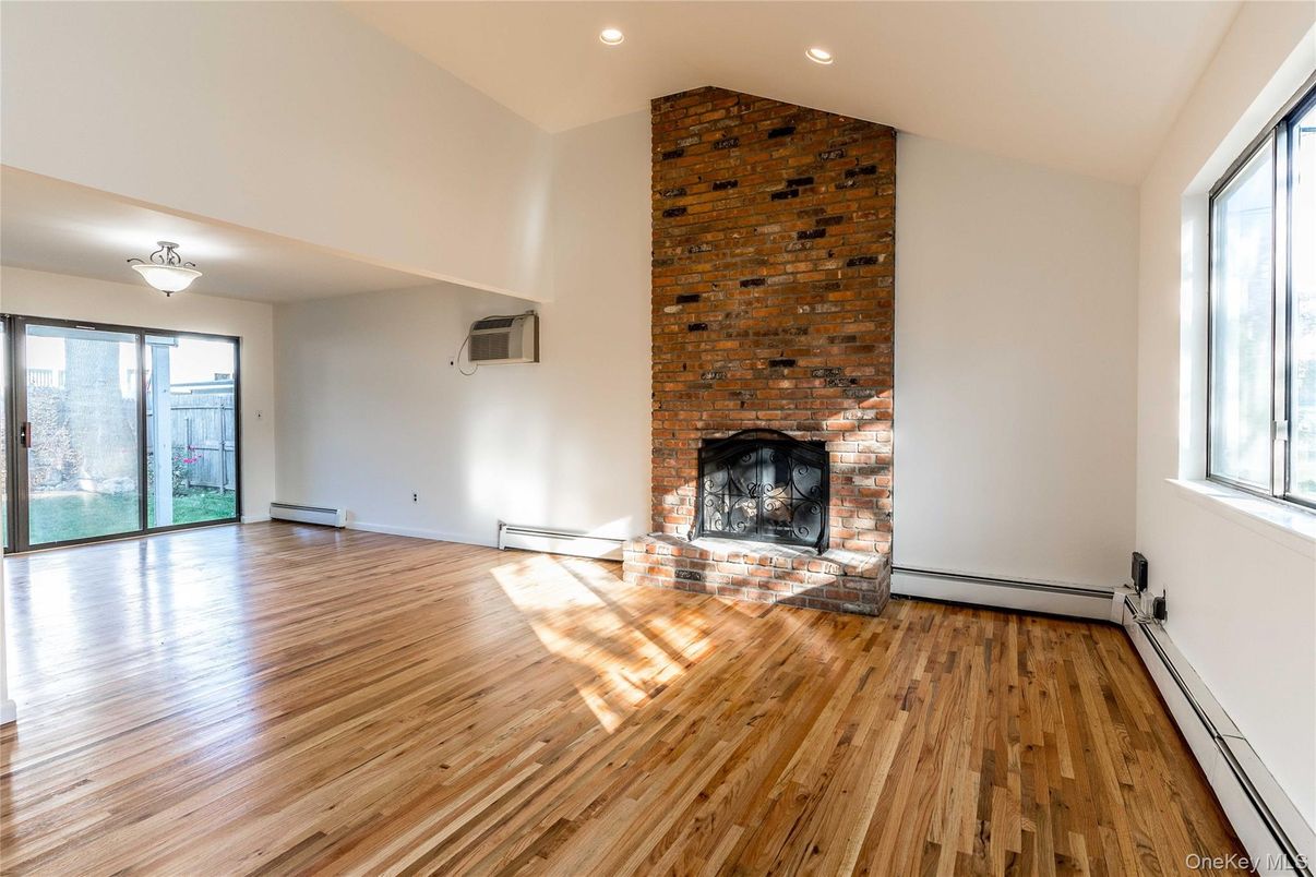 Empty room, Fireplace, Interior, Recessed Lighting, Stone Walls, Wood Texture Flooring