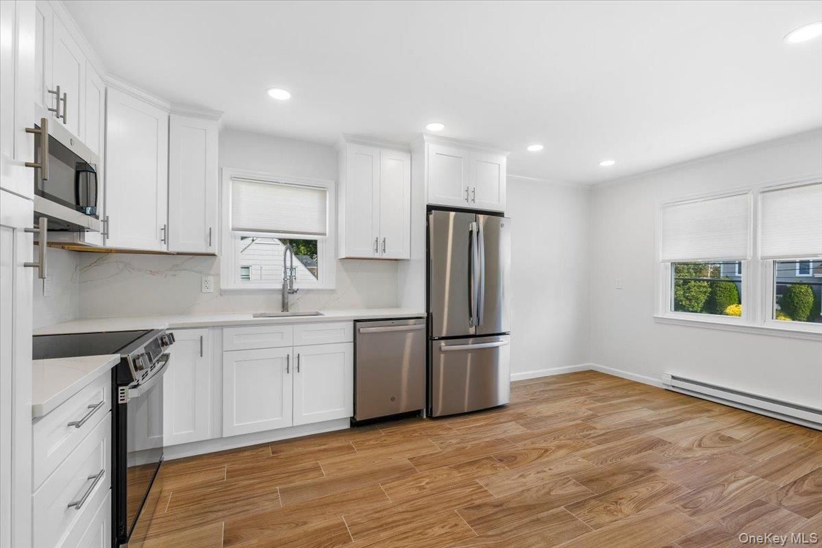 Interior, Kitchen, Marble Walls, Recessed Lighting, Stainless Steel Appliances, Wood Texture Flooring
